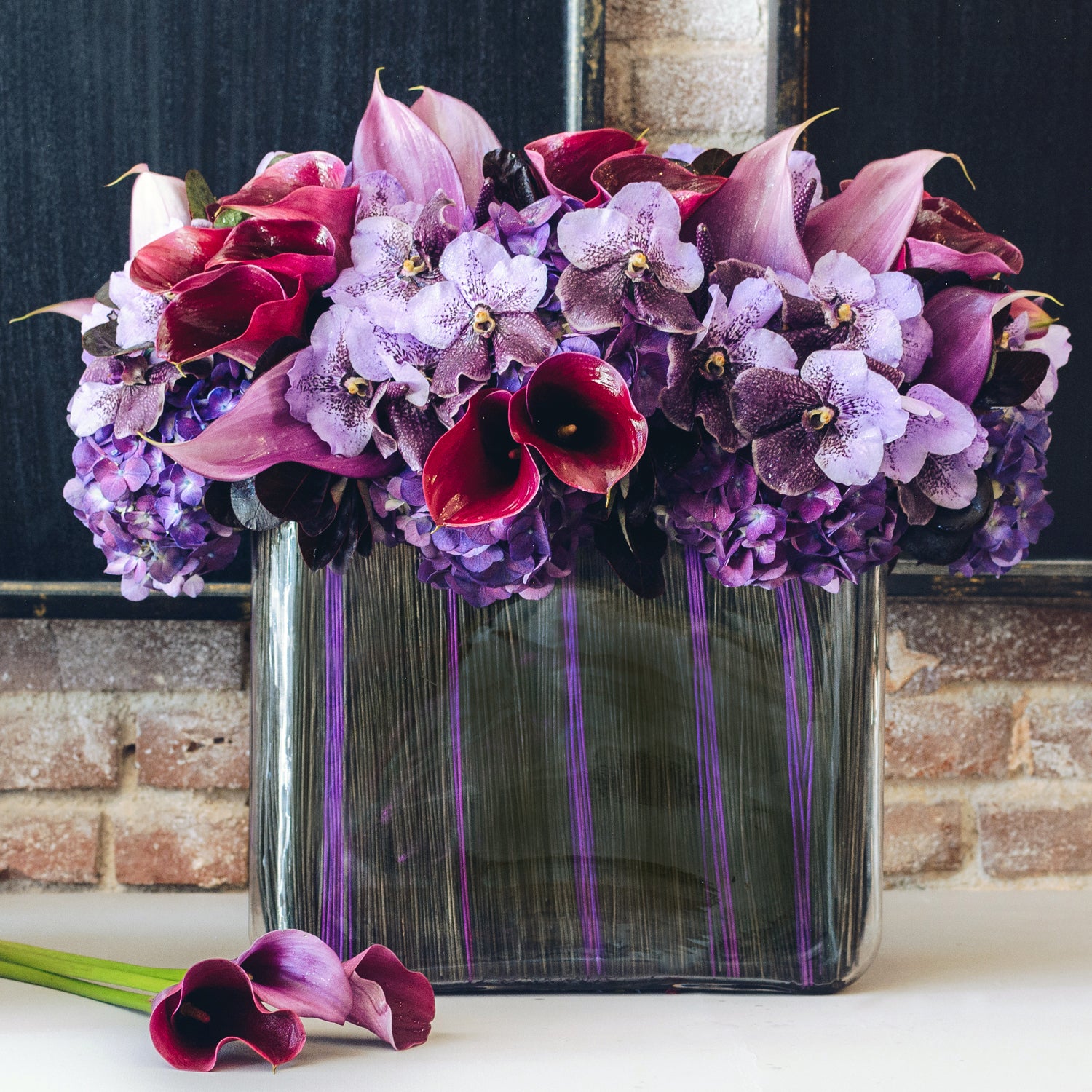 purple lily flower arrangements Purple Calla Lilies Floral Arrangement - Empty Vase